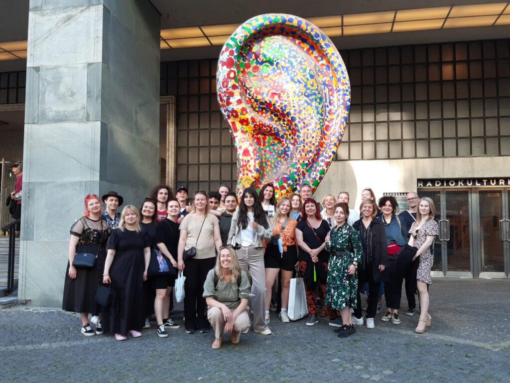 Group photo in front large ear sculpture at Funkhaus, Viennasc
