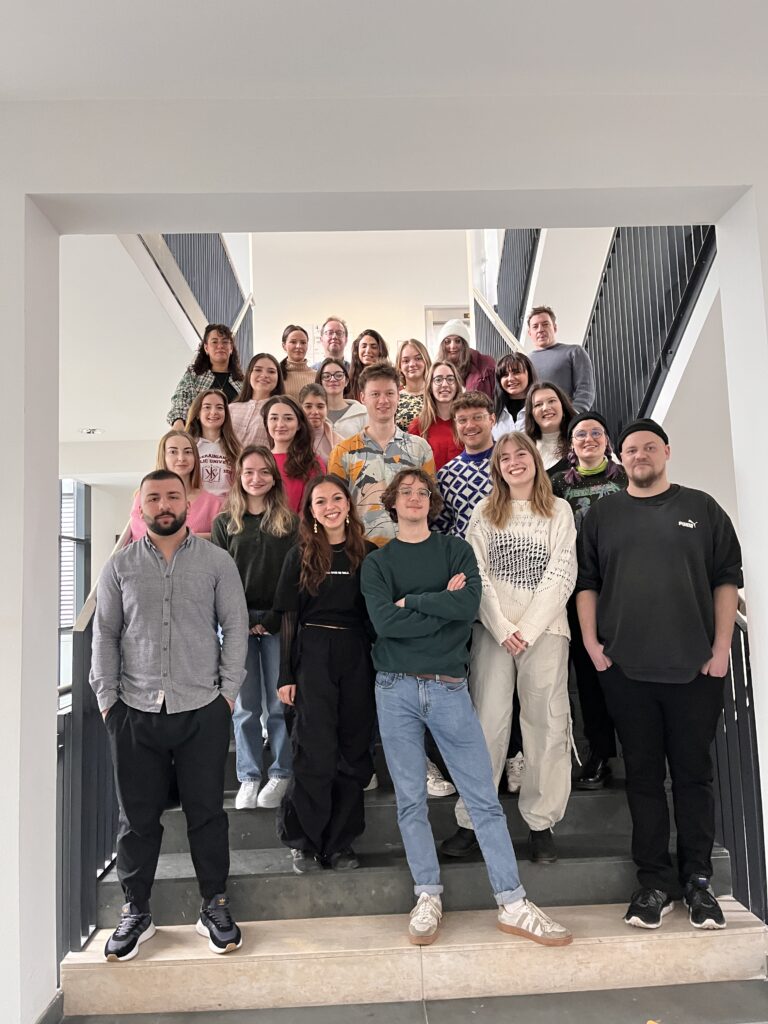 group photo on stairs of students during ismj project week 2023 in vienna